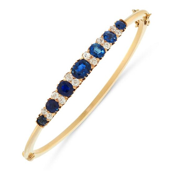AN UNHEATED SAPPHIRE AND DIAMOND BANGLE in yellow gold