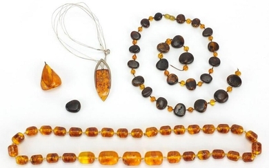 Amber coloured bead necklaces and loose beads