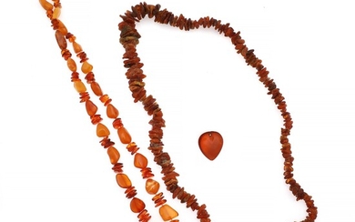 NOT SOLD. An amber jewellery set comprising of two necklaces and a pendant. (3) –...
