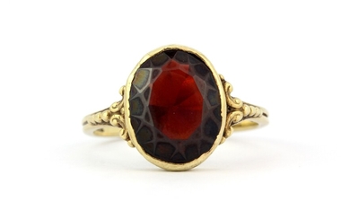 An antique Oriental yellow metal (stamped 333) ring set with a large oval cut garnet, (O.5).