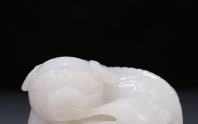An exquisite white jade lion ornament