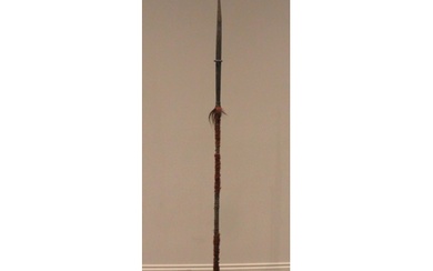 An iron spear stand, with twin loops supporting an iron barb...