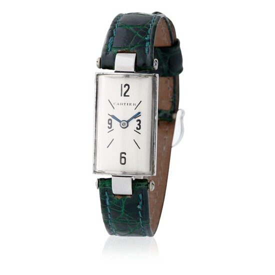 Cartier. Esteemed and Striking Petit Cylinder Shape Wristwatch in Steel, With Black baton and Arabic Numerals