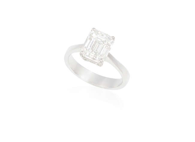 Description A DIAMOND SINGLE-STONE RING A rectangular-cut diamond weighing...