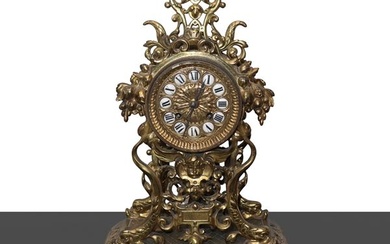 Gilt bronze table clock with cherubs and grape shoots.
