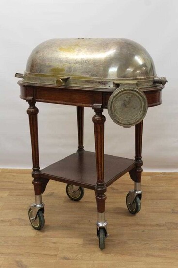 Impressive early 20th century mahogany serving trolley, with silver plated domed cylinder cover and folding dish stand, raised on fluted legs with tier below on substantial castors, 98cm wide