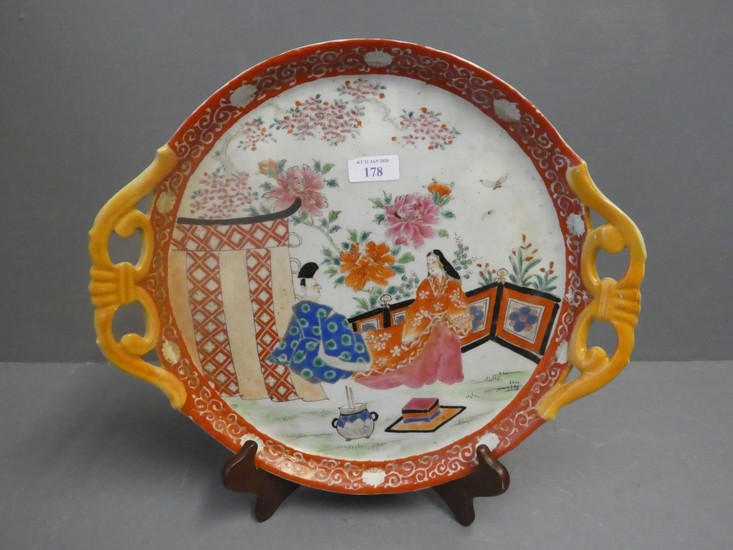 Japanese dish on a famille rose ground depicting 2 figures (...