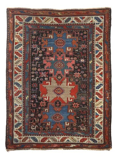 Karabagh with Lesghi stars Caucasus, c. 1900, wool on wool, 4 Lesghi stars and scattered motifs as well as small bird and quadruped abstractions on a black field, so-called saw blade wine glass border and a geometrically abstract vine border, LxW:...