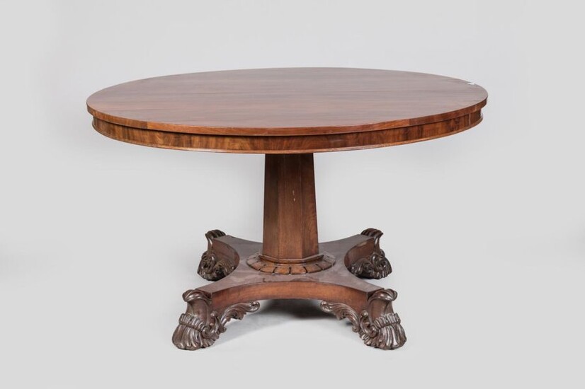 Mahogany and mahogany veneer dining room table resting on a...