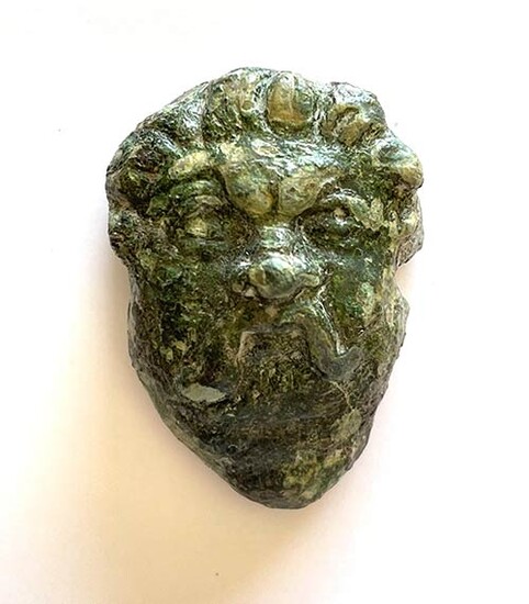 Roman bronze applique depicting a male head with mustache; ca....
