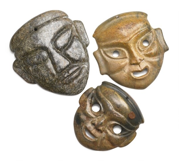 Three Chinese masks of brown and grey jade. Weight 5228 g. H. 22–28.5 cm. (3)