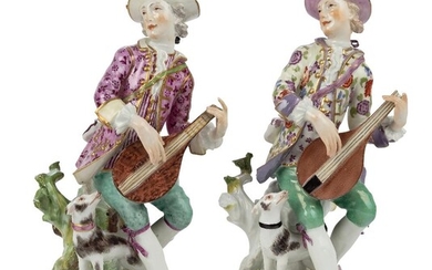 Two Meissen porcelain figures of musicians, c.1755, the decoration probably later, each playing a lute, seated on a tree-stump with a dog at their feet, on rococo scroll-moulded mound bases applied with flowers and foliage, 19.6cm and 20cm high (2)...