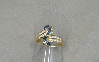 A yellow gold (eagle) ring set with six shuttle-cut sapphires...