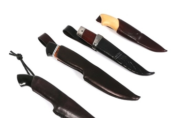 Four custom hunting knives in their scabbards.
