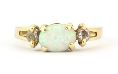 A 14ct yellow gold (stamped 14k) ring set with a cabochon oval cut opal and stone set shoulders, (possibly synthetic opal), (O.5).