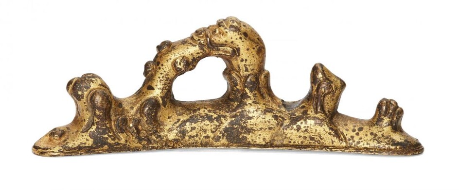 A Chinese gilt bronze brush rest, 18th century, cast as...