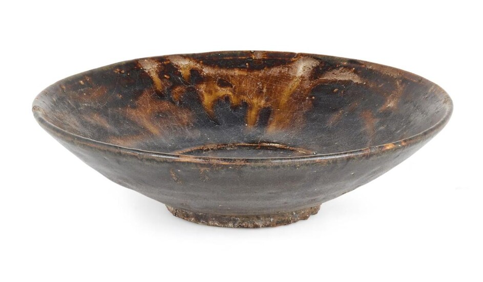 A Chinese stoneware tortoiseshell-glazed bowl, Yuan dynasty, on short foot with gently curving sides, covered in an allover treacle glaze with translucent splashes to the interior creating a 'tortoiseshell' effect, 16.2cm diameter