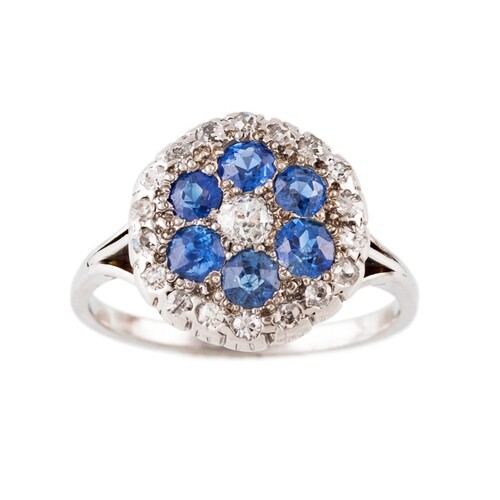 A DIAMOND AND SAPPHIRE CLUSTER RING, of circular for, mounte...