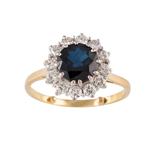 A DIAMOND AND SAPPHIRE CLUSTER RING, of circular form, mount...