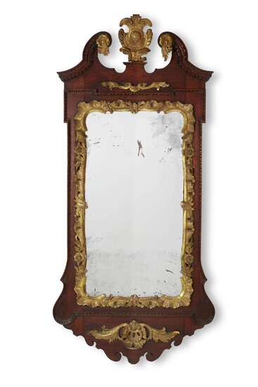 A GEORGE II CARVED MAHOGANY AND PARCEL GILT MIRROR