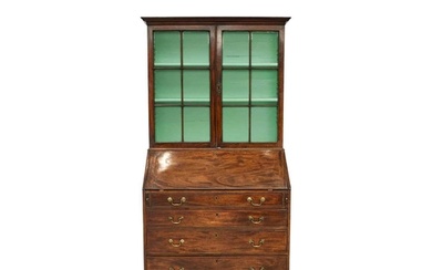 A George III mahogany bureau bookcase. The upper section wit...