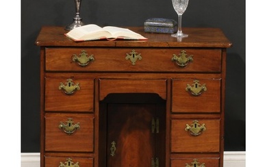 A George III mahogany kneehole desk, slightly oversailing to...