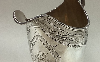 A George III silver jug with bright-cut decoration.