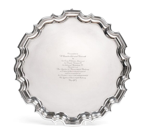 A George V Silver Salver, by Carrington and Co, London, 1922, shaped circular and on three pad...