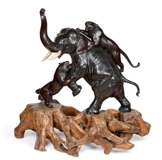 A Japanese Bronze Large Okimono, Meiji period, as an elephant being attacked by two tigers, the...