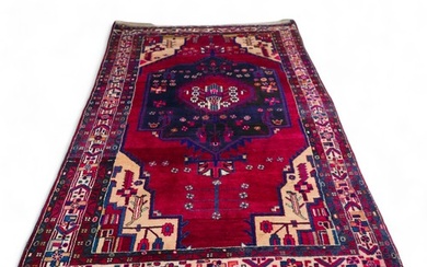 A Persian rug, with red ground and geometric floral decorati...