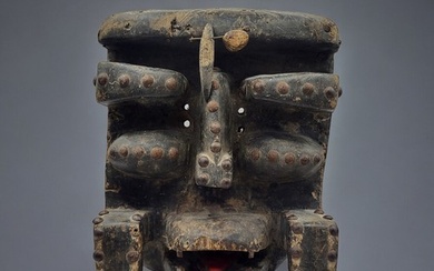 A SOUTH AMERICAN CARVED WOODEN MASK Protruding features with...