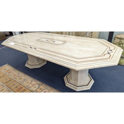 A Travertine marble dining table of elongated ocgtagonal for...