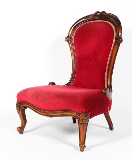 A Victorian carved mahogany nursing chair, the balloon shaped back carved with fruits