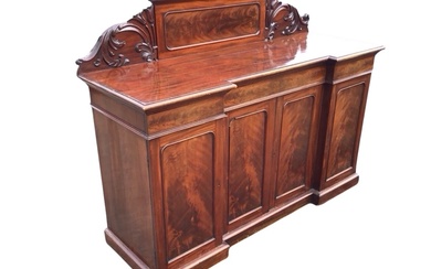 A Victorian mahogany inverted breakfront sideboard, the panelled back flanked...