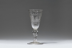 A cut glass goblet with a sailing ship on the ...