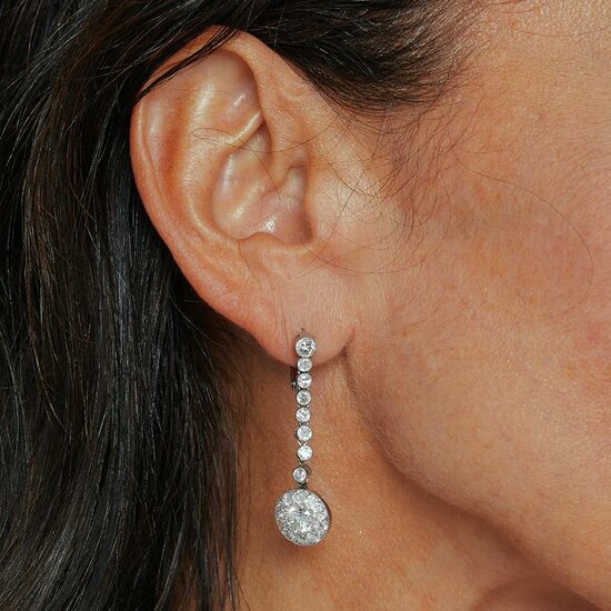 A diamond and platinum pair of ear pendants, circa