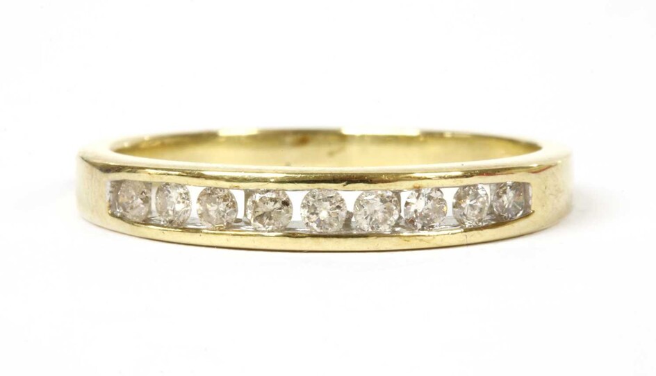 A gold diamond half eternity ring