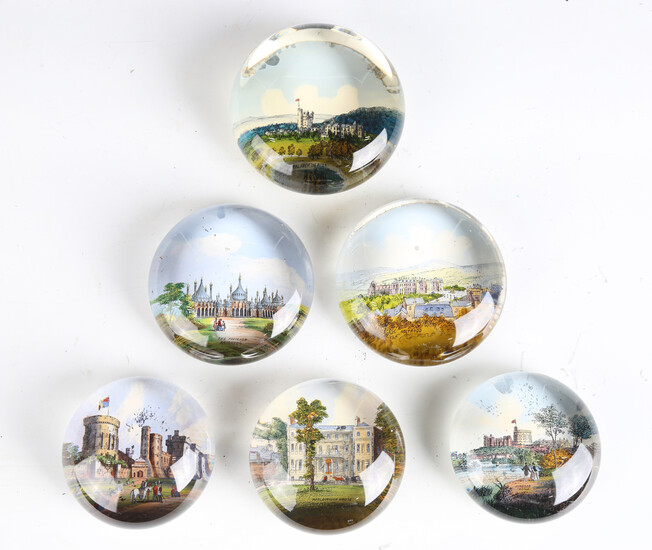 A group of six Victorian glass paperweights, all with printed scenes of Royal residences to the base