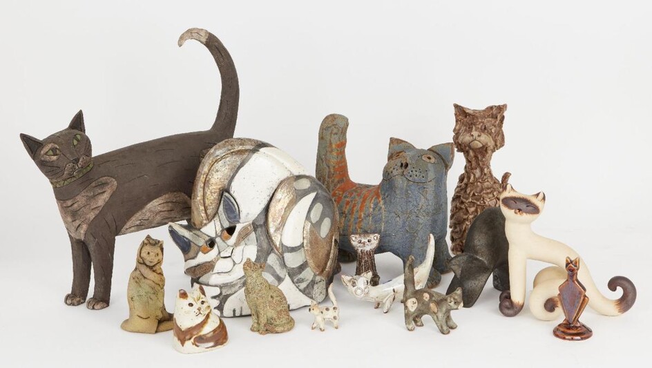 A group of studio pottery cats, to include; a pottery Cheshire cat by Eleanor Madonik (1929-2006), with pierced eyes, bearing incised signature and dated 1989 to underside, 21cm high, a large pottery cat with incised decoration, unmarked, 32cm...
