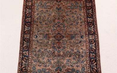 A large woollen Persian carpet with radiating foliate motif on...