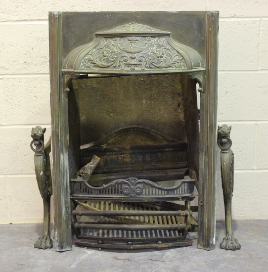 A late Victorian brass mounted bedroom fireplace with foliate cast hood and leopard headed supports