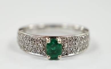 A modern 18ct white gold and single stone oval cut emerald s...