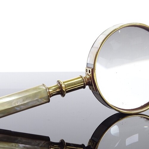 A mother-of-pearl and brass-mounted magnifying glass, length...