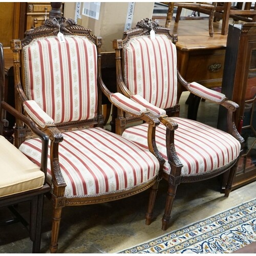 A pair of 19th century French carved walnut elbow chairs, wi...