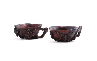 A pair of Chinese Huanghuali 'prunus and lotus' cups
