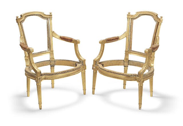 A pair of Louis XVI un-upholstered giltwood fauteuils or open armchairs