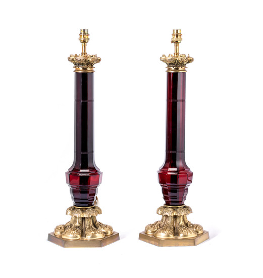A pair of brass mounted ruby glass lamp bases