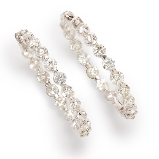 A pair of diamond and fourteen karat white gold earrings