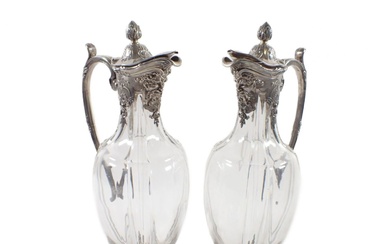 A pair of glass Regency style jugs in silver from...