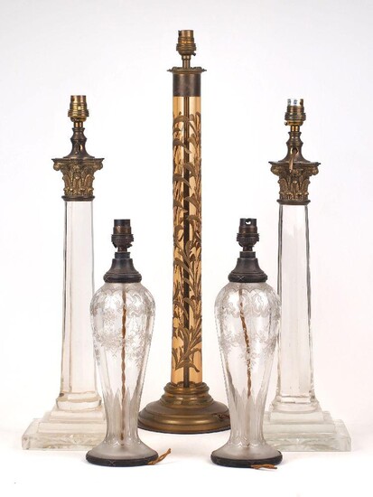 A pair of glass column table lamps, late 20th century, each with gilt-metal capital and tapering octagonal shaft, 43cm high; together with a pair of etched glass vase lamps, 20th century, decorated with ribbon-tied floral garlands, 28cm high; and a...